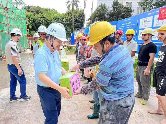 岑廷義為一線工人發放清涼飲品。 謝秋云 攝（650圖）.jpg